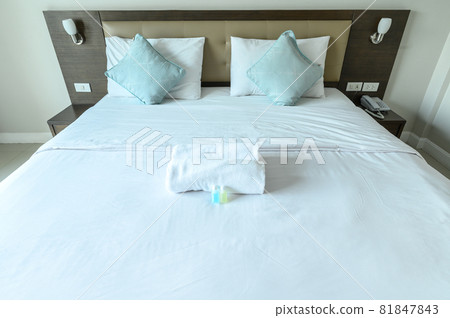 View of comfortable bed in hotel bedroom decoration in cozy style. Conceptual of a room in a home where people sleep. View of comfortable bed in hotel bedroom decoration in cozy style. Conceptual of a room in a home where people sleep. 81847843