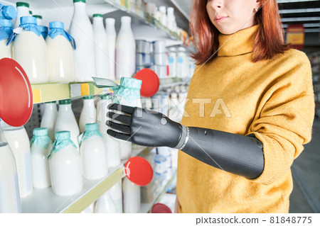 Woman holding yogurt in her hands while reads the label 81848775