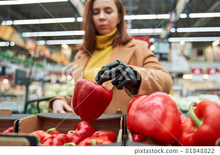 Woman with prosthesis arm with red pepper in hand 81848822