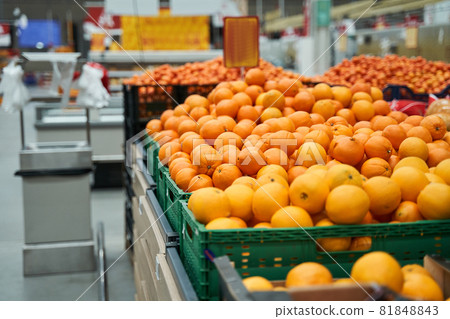 A lot of oranges laying at the shelves 81848843