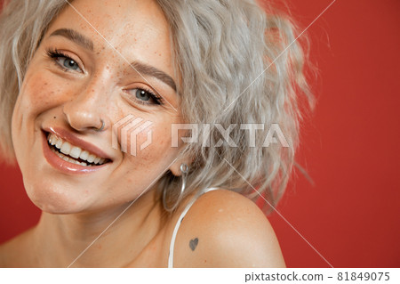 Woman smiling widely and looking happy Woman smiling widely and looking happy 81849075