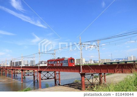 Chinchin train crossing the Yamato River [Osaka] 81849844