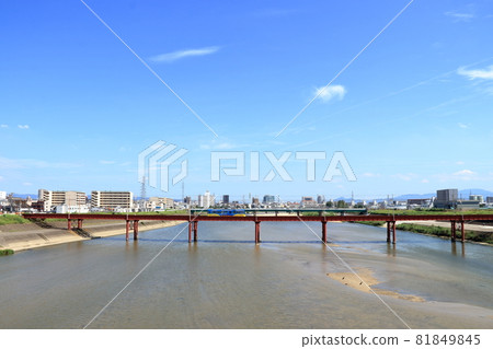 Chinchin train crossing the Yamato River [Osaka] 81849845
