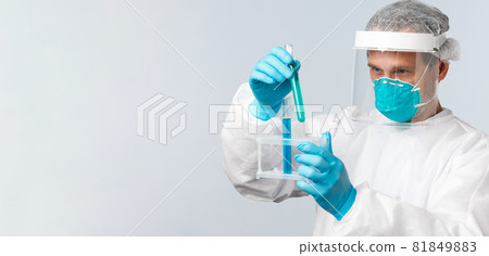 Covid-19, preventing virus, healthcare workers and vaccination concept. Tech lab doctor in clinic wearing personal protective equipment working over vaccine, looking at test-tubes samples Covid-19, preventing virus, healthcare workers and vaccination concept. Tech lab doctor in clinic wearing personal protective equipment working over vaccine, looking at test-tubes samples 81849883
