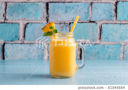 Tropical pineapple smoothie in a mason jar. Tropical pineapple smoothie in a mason jar. 81849884