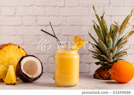 Tropical pineapple smoothie in a mason jar. 81849886
