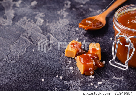 Glass jar with tasty delicious salted caramel 81849894