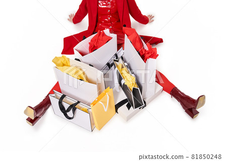 Woman sitting around a lot of paper bags Woman sitting around a lot of paper bags 81850248