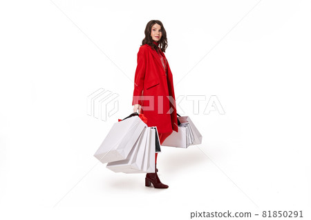 Woman wearing red clothes holding white shopping bags Woman wearing red clothes holding white shopping bags 81850291