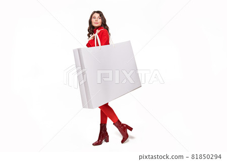 Girl looking away with white large shopping bag Girl looking away with white large shopping bag 81850294