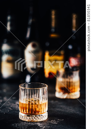 Whiskey with ice on a dark table 81850341