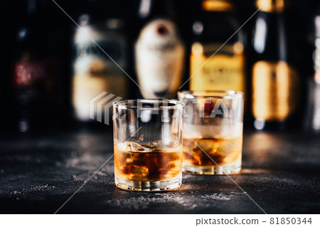 Whiskey with ice on a dark table 81850344