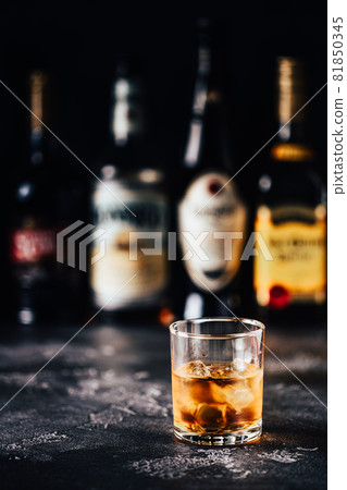 Whiskey with ice on a dark table Whiskey with ice on a dark table 81850345