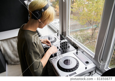 Woman with stylish hairstyle wearing studio headphones 81850877