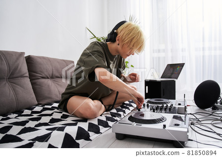 Woman adjusting her dj console Woman adjusting her dj console 81850894
