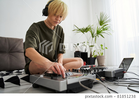 Woman wearing headphones push the button Woman wearing headphones push the button 81851238