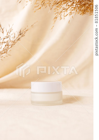 Cream beauty product mockup on linen drapery and dry branch of meadow plant. Concept eco organic cosmetic with natural extracts. Mock up skincare cosmetic product 81851506