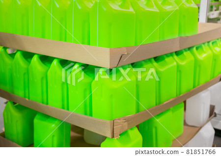 Stacks of many empty green plastic jerrycans 81851766
