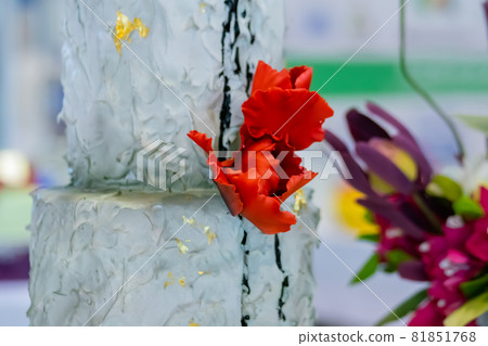 Birthday aquamarine dessert cake with red flowers - close up 81851768