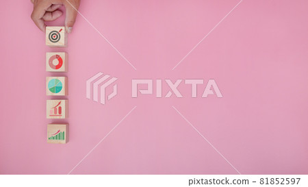 Hand arranging wood block with icon business strategy and action plan. 81852597