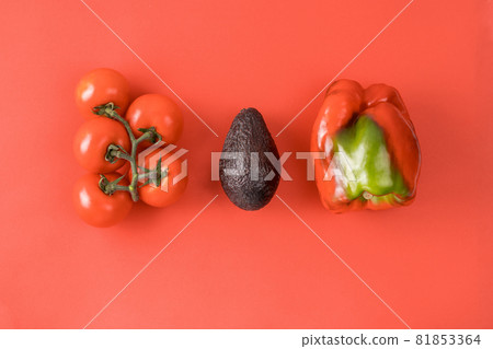 Layout made of avocado, tomato and pepper. Food concept. Vegetables on red background. Minimal summer concept. Vegetable design. Layout made of avocado, tomato and pepper. Food concept. Vegetables on red background. Minimal summer concept. Vegetable design. 81853364