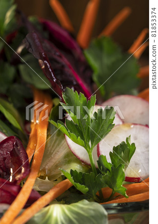 Fresh mix vegetable salad on rustic brown wooden background. Macro Fresh mix vegetable salad on rustic brown wooden background. Macro 81853374