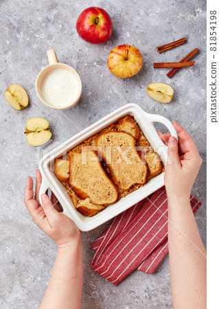Bread pudding breakfast casserole made from wheat bread, eggs, milk and grated apples Bread pudding breakfast casserole made from wheat bread, eggs, milk and grated apples 81854198