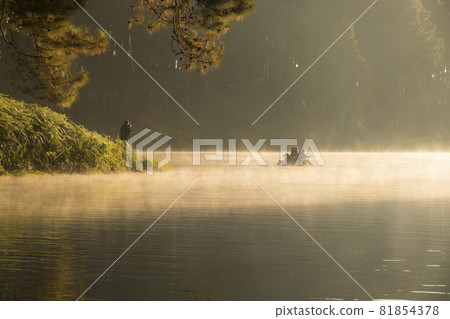 beautiful scenery - bamboo rafting through the mist on the lake in morning at Pang-ung, in Mae Hong Son,Thailand beautiful scenery - bamboo rafting through the mist on the lake in morning at Pang-ung, in Mae Hong Son,Thailand 81854378