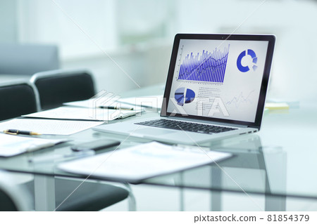 laptop, clipboard and financial data on the businessman's Desk 81854379