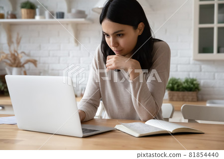Happy beautiful young asian woman studying online using computer. Happy beautiful young asian woman studying online using computer. 81854440