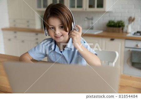 Cute little child boy in headphones holding video call. 81854484