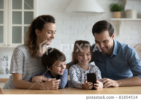 Happy parents and kids using mobile phone for video call 81854514