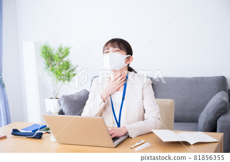 A woman suffering from throat upset at work A woman suffering from throat upset at work 81856355