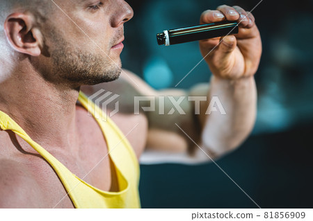 muscular athlete male drink liquid vitamin b 12 or supplement in black bottle muscular athlete male drink liquid vitamin b 12 or supplement in black bottle 81856909