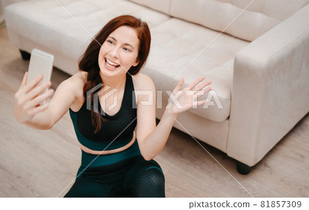 Young athlete coach is welcomed by fitness students online. Young athlete coach is welcomed by fitness students online. 81857309