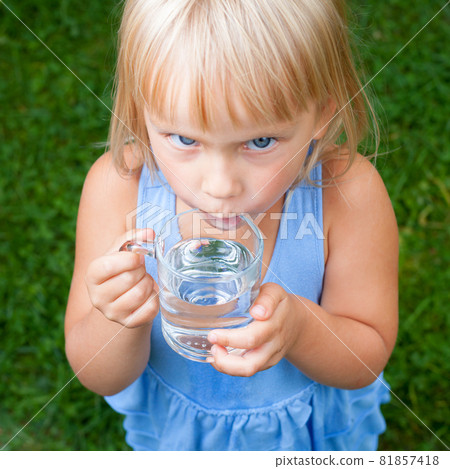 Child drinking water outdoors Child drinking water outdoors 81857418