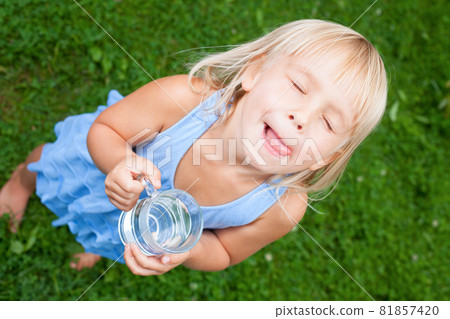 Child enjoy drinking water outdoors Child enjoy drinking water outdoors 81857420