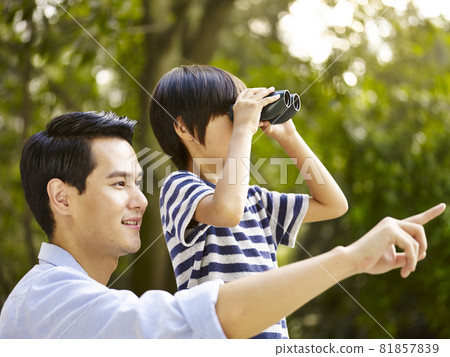 asian father and son using binoculars in park asian father and son using binoculars in park 81857839