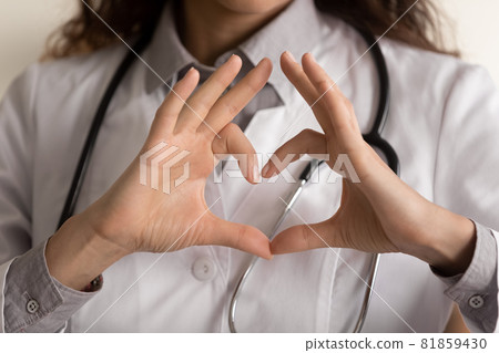 Female doctor making hand and finger heart shape 81859430