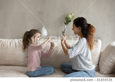 Adorable girl practicing communication with caring mum. 81859726
