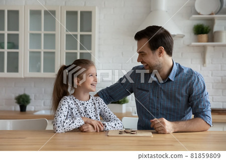 Joyful excited daddy and daughter kid playing checker draughts 81859809