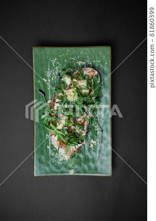 top view of bruschetta or toast bread with salmon or arugula on black background 81860399