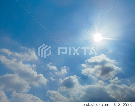 The sun shining in the blue sky with clouds 81860558