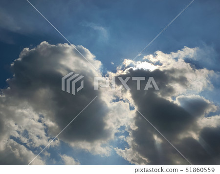 Clouds floating in the blue sky that hides the sun 81860559