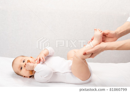Little baby receiving foot massage in pediatric clinic Little baby receiving foot massage in pediatric clinic 81860799