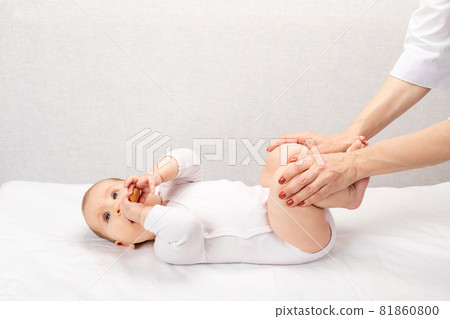 Little baby receiving osteopathic treatment of her leg to prevent hip dysplasia by pediatric physiotherapist Little baby receiving osteopathic treatment of her leg to prevent hip dysplasia by pediatric physiotherapist 81860800