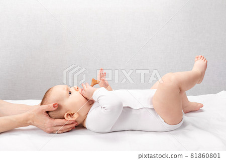 Little baby receiving osteopathic treatment of head and neck Little baby receiving osteopathic treatment of head and neck 81860801