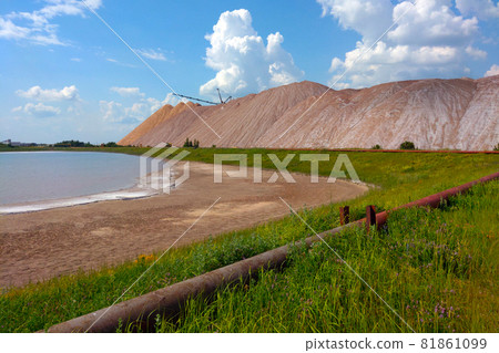 View of the extraction of potash fertilizers, minerals. Mountains of empty ore when mining potassium. Mining industry in Soligorsk, Belarus. View of the extraction of potash fertilizers, minerals. Mountains of empty ore when mining potassium. Mining industry in Soligorsk, Belarus. 81861099
