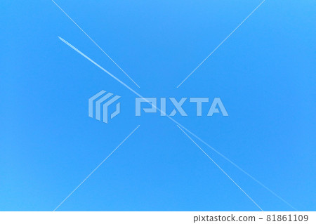 An airplane is flying against the background of the blue sky. Transportation of tourists to exotic vacations. 81861109