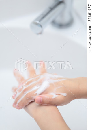 Girl washing hands with hand soap on the wash basin Girl washing hands with hand soap on the wash basin 81861977